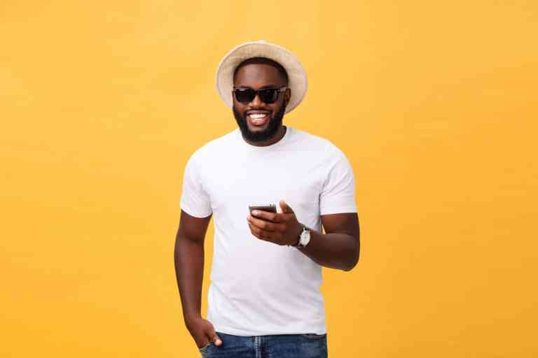 cheerful-african-american-man-white-shirt-using-mobile-phone-application